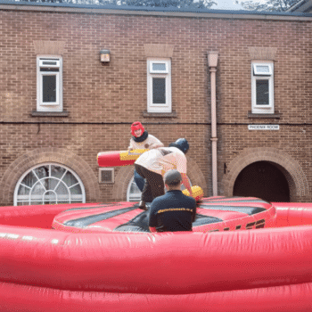 Rock n Roller jousting inflatable hire with two players battling on a moving platform