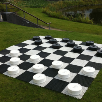Giant draughts hire set up outdoors on grass for wedding entertainment in the UK